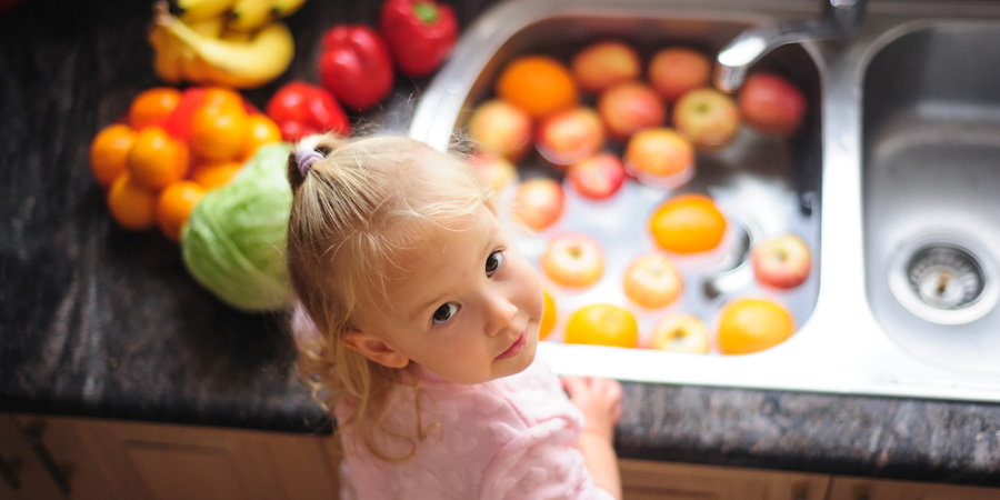 Little girl washing fruits and vegetables - GFVN April 2022